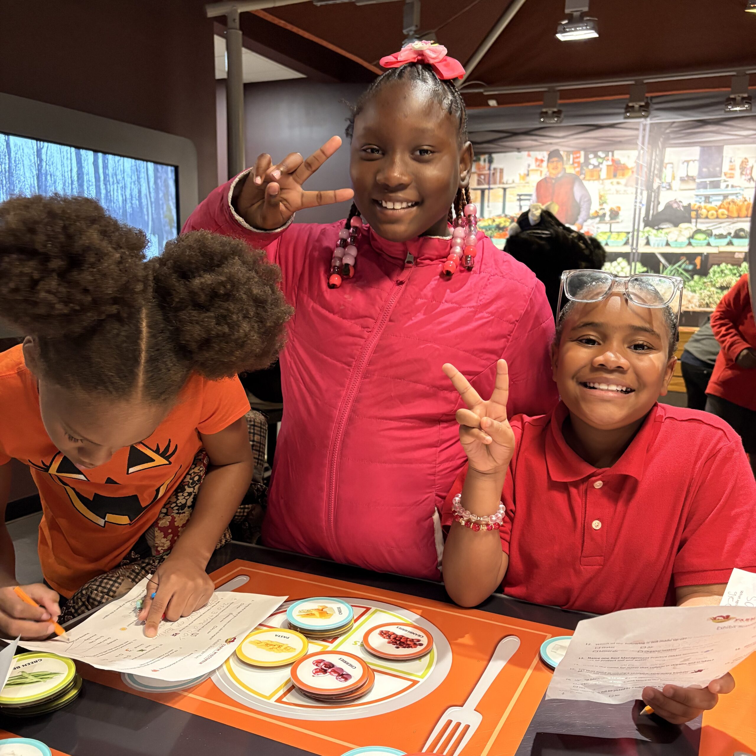 Two young students pose for a photo in the Farm Wisconsin Exhibits